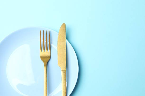istock Blue plate with cutlery on a colored background 2254018994
