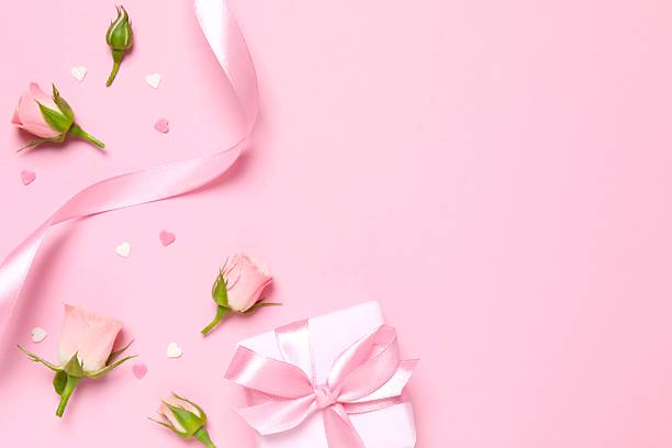 istock Beautiful composition with pink roses and gift box on color background 2254019018