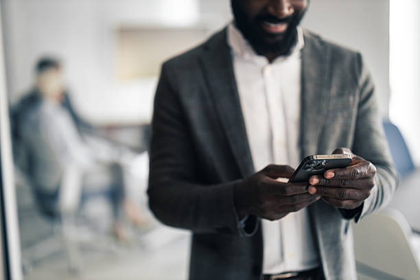 istock Professional Man in Blazer Using Smartphone in Modern Office Setting for Business Communication 2254019660