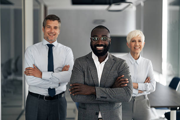 istock Confident Team Leader Front With Diverse Colleagues Behind, Smiling In Modern Office Setting 2254019711