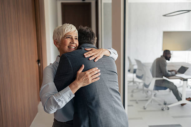istock Warm Office Hug Between Colleagues, Smiling Woman Embracing Man in Modern Workspace 2254019762