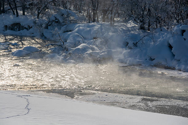 Steam rising from the river surface on a cold winter morning