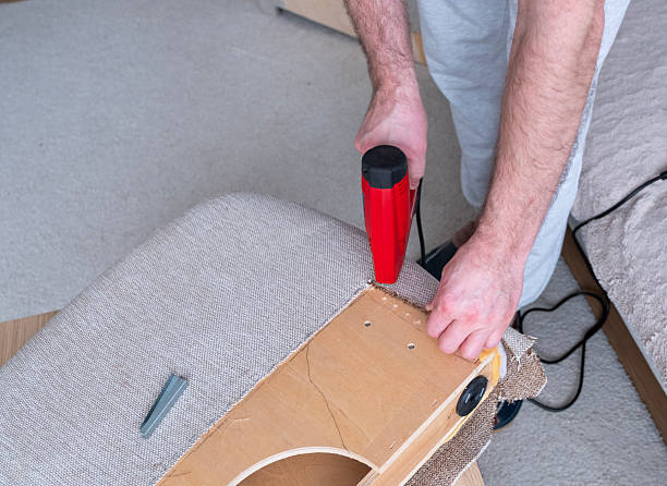 istock Upholstery work. A Caucasian man with a stapler for upholstery work. 2254026779