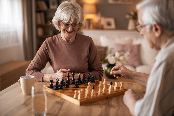 istock Warm Home Chess Match Between Elderly Couple Sharing Smiles and Strategy 2254036267