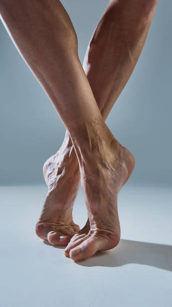 istock Bare ballet feet on demi-pointe revealing emotional raw strength and texture 2254038700