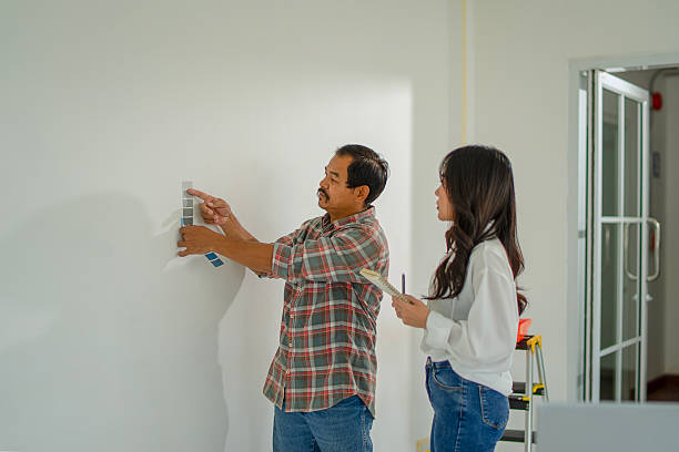 istock The painter is painting the house's wall. 2254040578