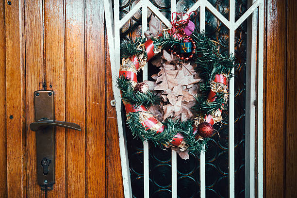 Front door of house with decorative New Year's wreath, close-up detail.