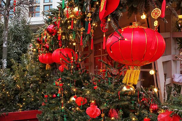 istock Christmas and Chinese New Year celebration decorations combining red lanterns and green trees 2254043820