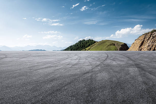 istock Empty asphalt road and green mountain scenery under blue sky. 2254044174