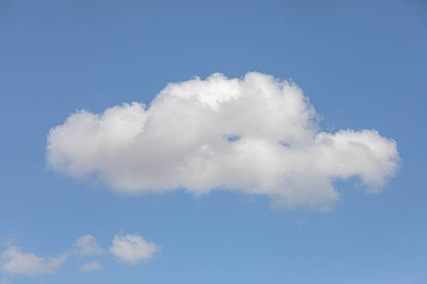 Closeup of Billowy cumulus clouds. Wispy clouds, deep blue sky in background.