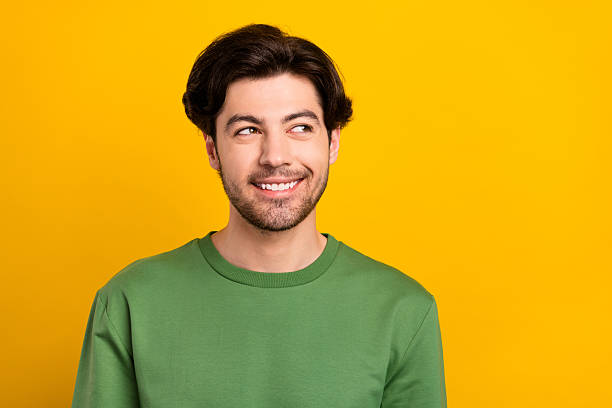 istock Photo of positive dreamy curious guy look empty space wear green pullover isolated yellow color background 2254046842