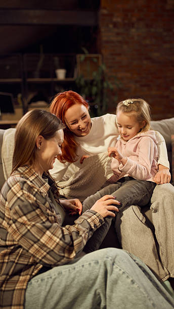 istock Family watching child play while relaxing on sofa at home 2254047686
