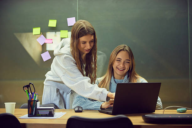 istock Two young women studying together with laptop in friendly classroom mood 2254051495