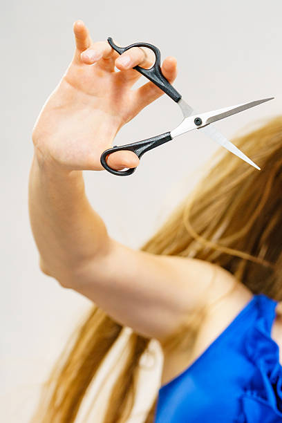 istock Woman with scissors ready to hair cutting 2254052531