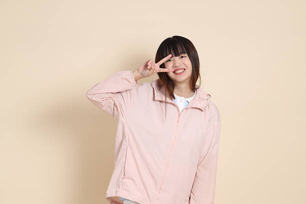 istock 20s Asian woman in pink UV jacket 2254053176