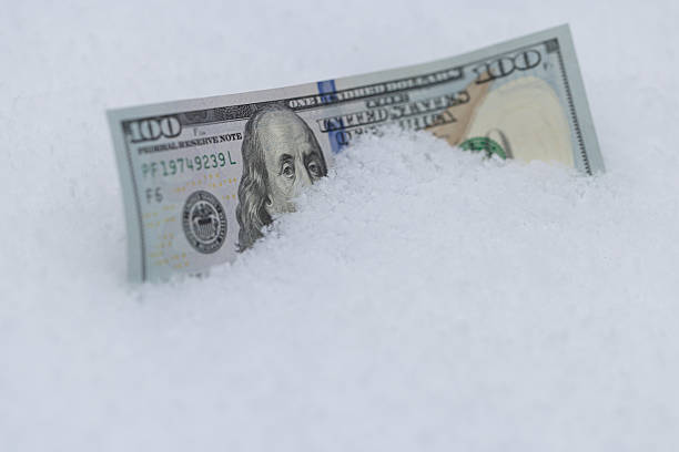 istock One Hundred Dollar Bill Buried in Snow 2254057481