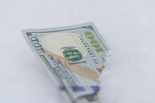 istock One Hundred Dollar Bill Buried in Snow 2254057531