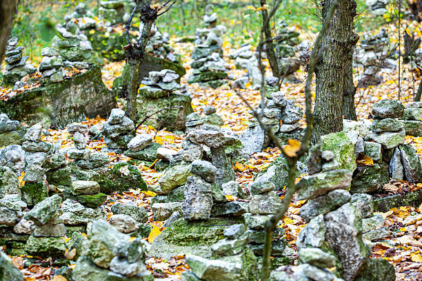 stack of smooth river stones standing in the middle of a shallow stream. High quality photo