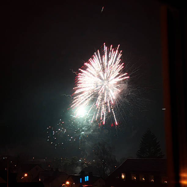istock Bright Firework Explosion Over a Dark Suburban Neighborhood at Night 2254064882