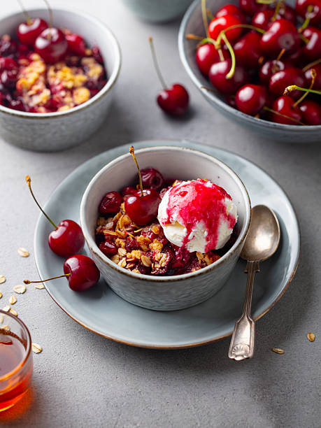 istock Cherry crumble dessert with vanilla ice cream. Grey background. 2254067654
