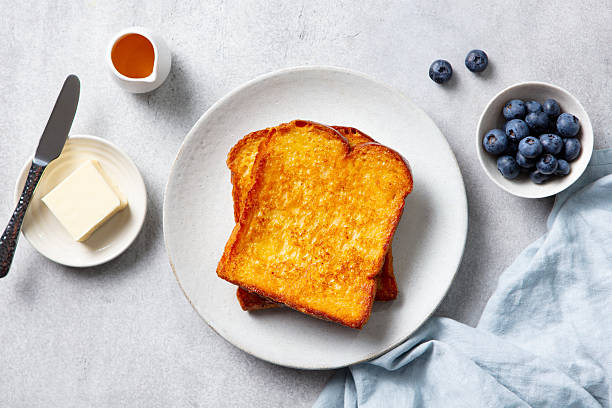 istock French toast with maple syrup and fresh blueberries. Grey background. Top view. 2254067809