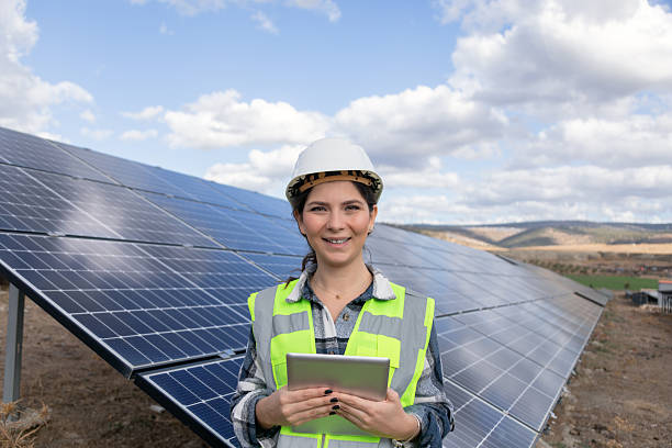 istock Female Renewable Energy Engineer Using Tablet With AI Powered Solar Panel Monitoring System at Solar Power Plant 2254068437