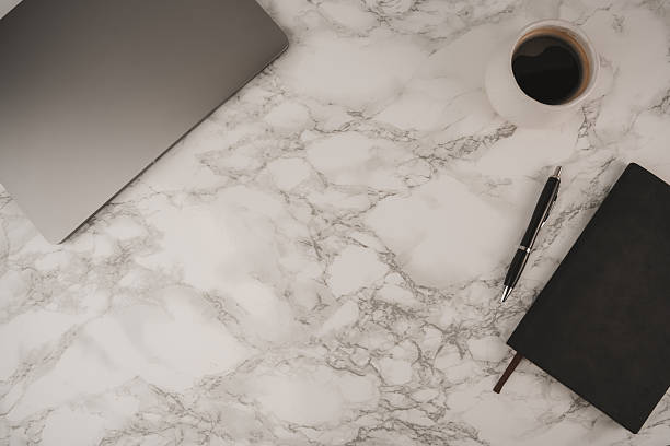 istock A clean workspace features a laptop, a cup of coffee, and a notebook on a marble surface. This setting offers ample negative space for text and inspiration, perfect for work or study 2254070521