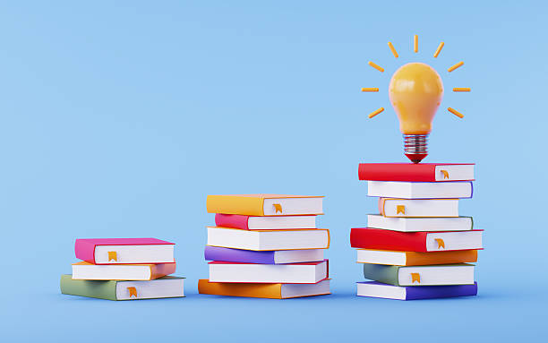 istock Yellow Light Bulb on Multi-Color Books Over Blue Background 2254071123