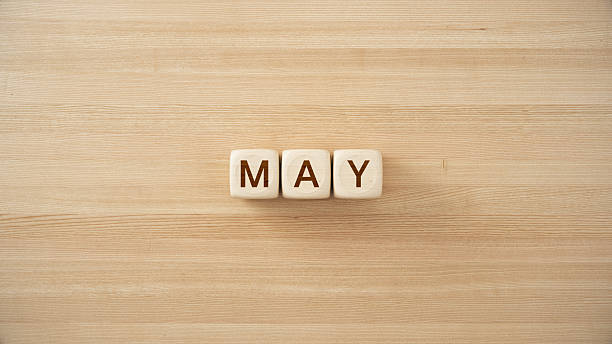 istock May word with Wooden Blocks on Wood Table. 3d rendering. 2254071424