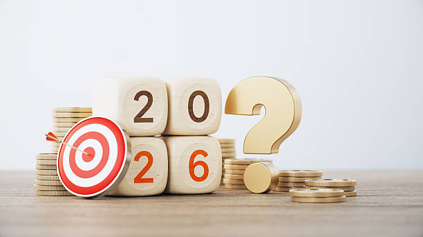 istock 2026 Written Wood Blocks and Red Bull's Eye Target on Coin Stacks with Question Mark Before Defocused Background. 2254071699
