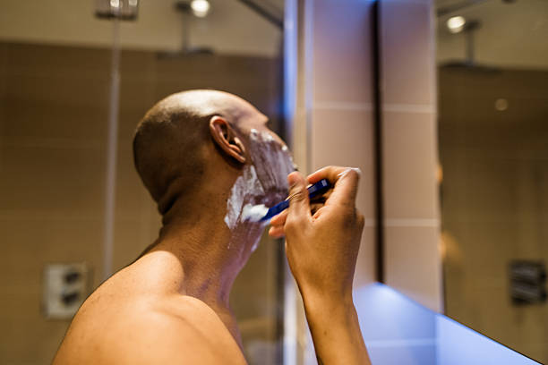 man take car of itself in the bathroom