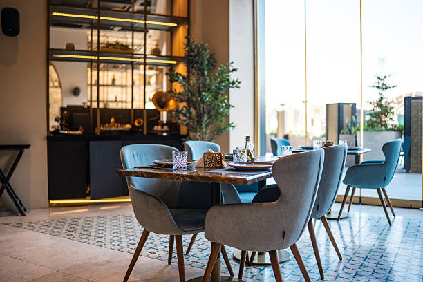 istock Contemporary Restaurant Dining Area with Blue Chairs and Sunlit Decor 2254072983