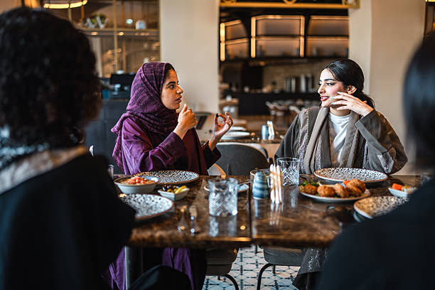 istock Joyful Arab Women Conversing and Dining at Upscale Restaurant Table 2254073063
