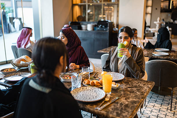 istock Young Arab Women Enjoying Refreshing Drinks at Modern Dining Spot 2254073065