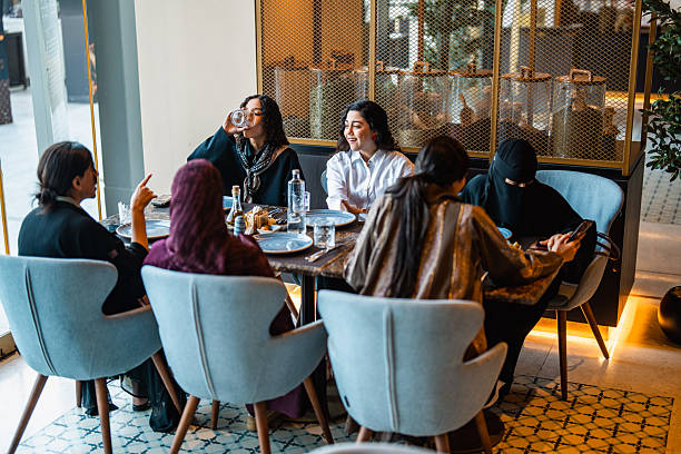 istock Young Middle Eastern Women Sharing Lively Meal in Upscale Setting 2254073113