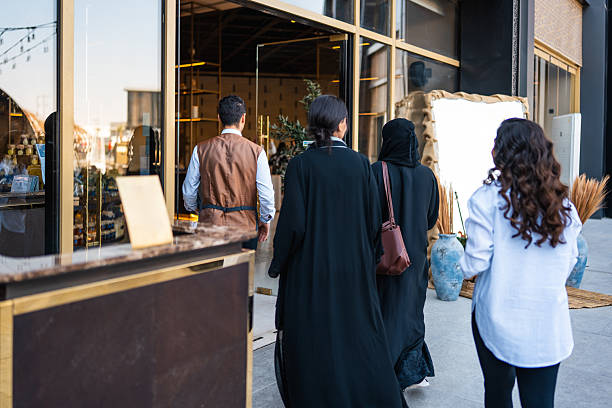 istock Arab Women Entering Upscale Dining Venue with Escort 2254073169