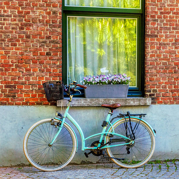Retro styled bicycle parked by a boulevard in front of a shop on the streets of Paris France