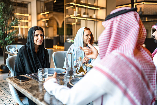 istock Arab Friends Engaging in Joyful Meal at Fine Dining Restaurant 2254076100