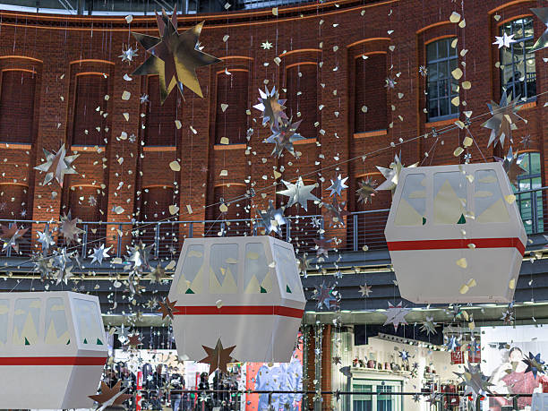 Christmas decor and decorations on the ceiling of a shopping mall. decorative poinsettias and Christmas lights.