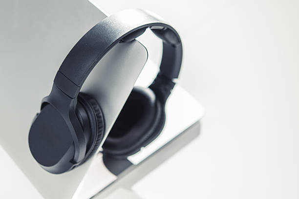 istock Headphones Rest on a Laptop in a Bright Workspace During the Day 2254077657