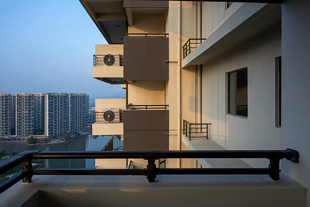 A panoramic view of an urban skyline featuring high-rise buildings and residential complexes, with a river running through the cityscape. The image captures the contrast between modern architecture and natural elements, evoking a sense of bustling city life.