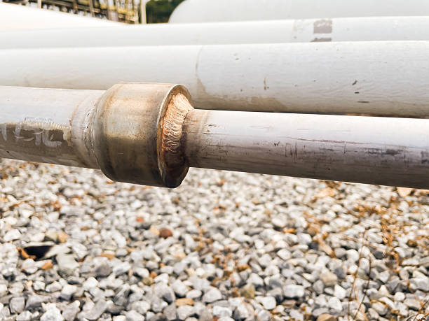 Close-up view of a welded metal pipe joint in an industrial pipeline system, showing fabrication quality, structural strength, and engineering detail. Suitable for industrial maintenance, construction, and infrastructure concepts.