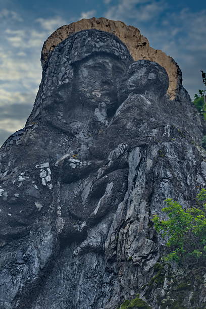 Chemal, Russia. May 11, 2025. A bas-relief of the Mother of God with baby Jesus in her arms, carved right on top of a cliff on the island of Patmos on the Katun River.