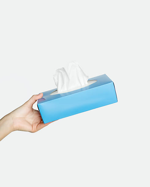 istock Hand holding a blue box of facial tissues 2254078197