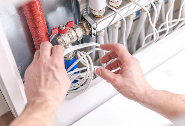istock Maintenance of Plumbing System With Hands Adjusting Valve and Pipes 2254079157