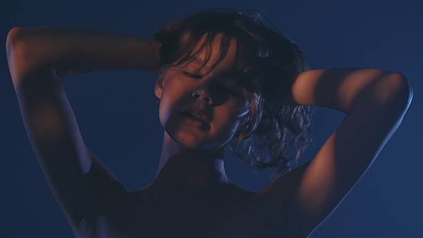 istock Mysterious Woman in Dramatic Lighting Portrait 2254081326