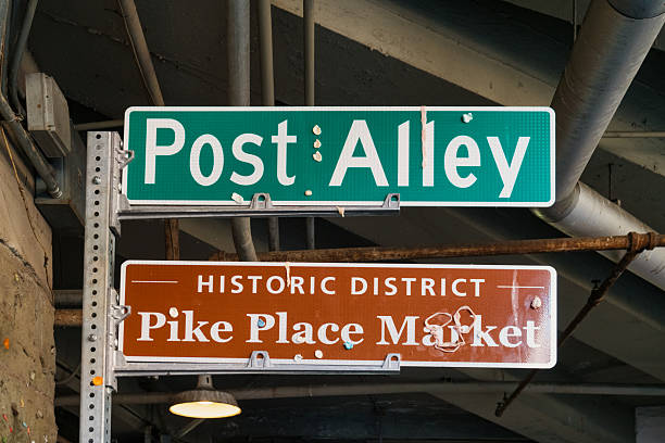 Post Alley and Pike Place Market sign in Seattle, Washington, USA, on a sunny day.