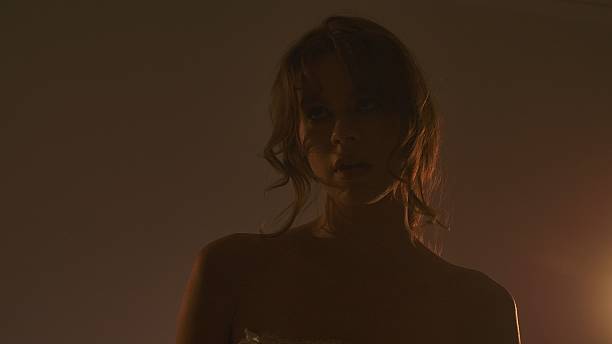istock A woman in dim lighting with dramatic shadows 2254082252
