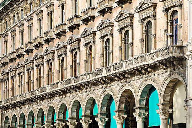 Arcaded building facade on Piazza del Duomo in Milan, Lombardy, Italy. The historic structure features a continuous series of arches and upper-level windows forming part of the urban setting surrounding the cathedral square.