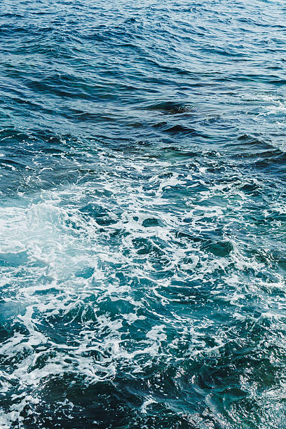 istock Waves crashing on a serene ocean surface during a sunny afternoon near the coast 2254083365